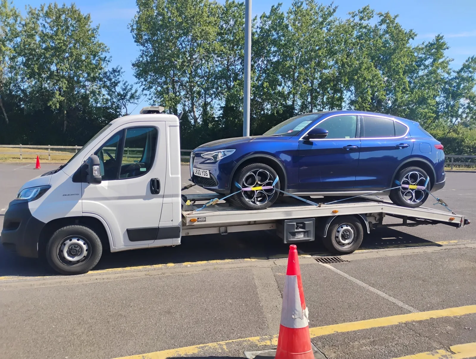Blue Alfa Romeo Stelvio secured on the transporter