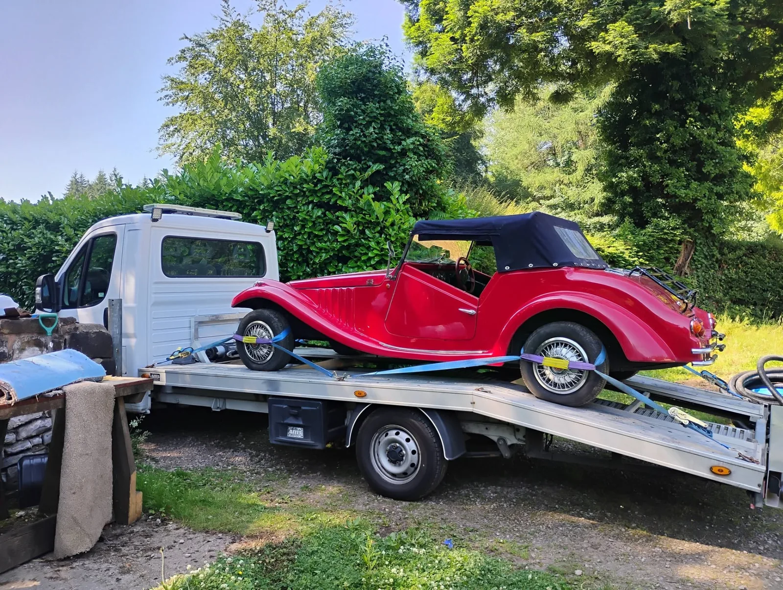 Red Pilgrim Bulldog kit car winched onto the transporter in Cinderford