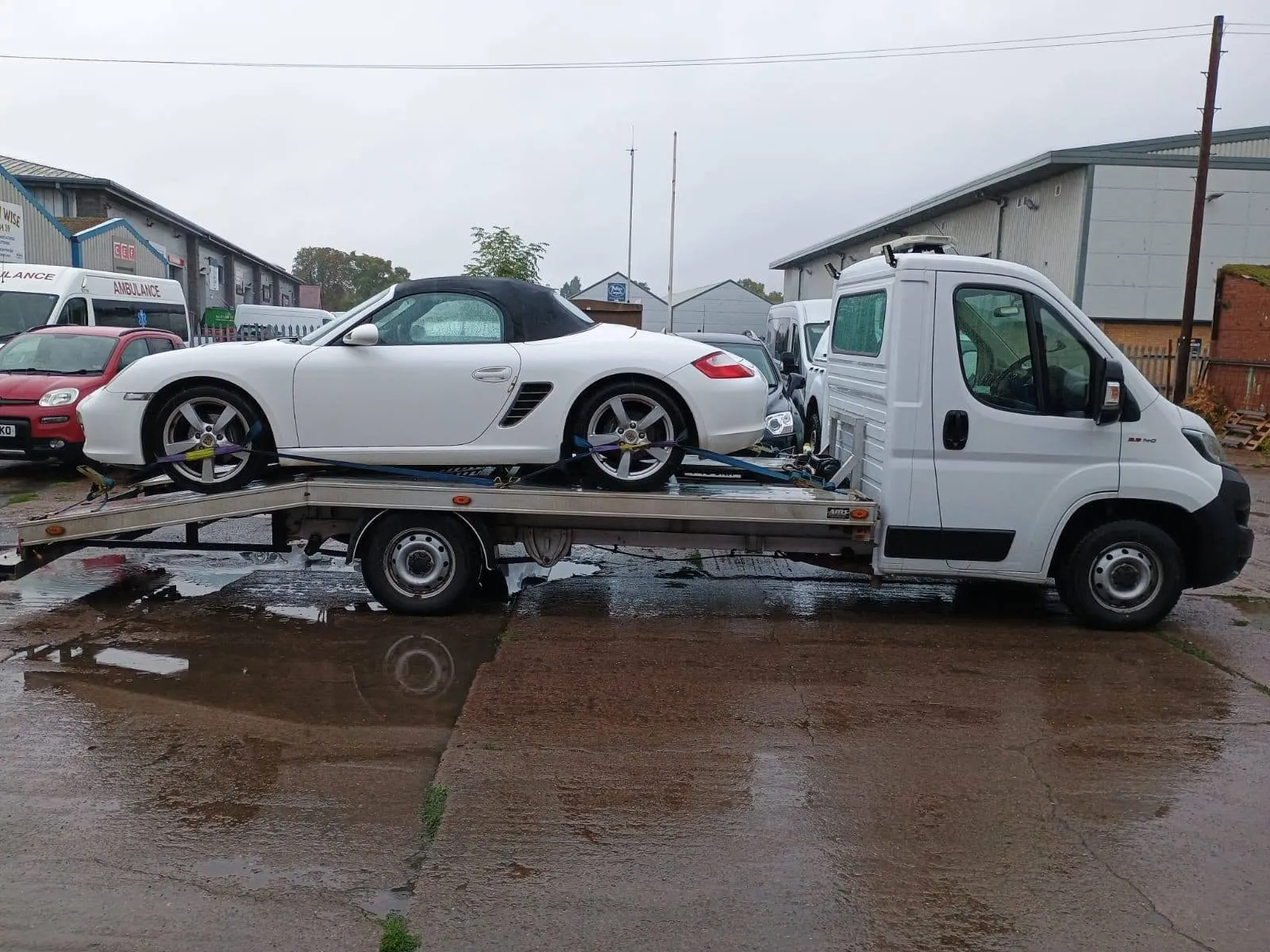 White Porsche Boxster strapped onto Ian's transporter for delivery to Hereford MOT and Service Centre
