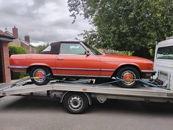 Classic orange Mercedes 280 SL convertible strapped onto Ian's transporter near Ross-on-Wye